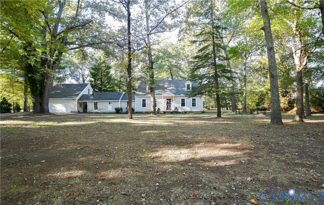 3486 Venter Road, Minors Pines, Aylett, VA 23009 Exterior of a light-colored residence featuring a gabled roof, an attached garage, and mature trees situated on a spacious lot