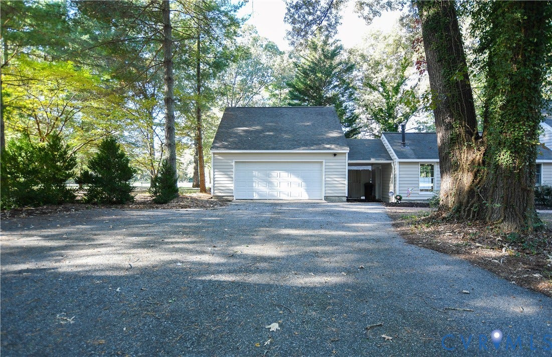 3486 Venter Road, Minors Pines, Aylett, VA 23009 Attached garage with horizontal siding, shingled roof, asphalt driveway, and wooded grounds