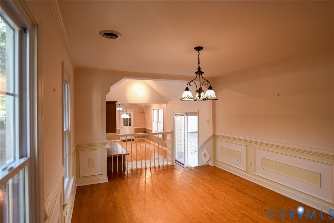 3486 Venter Road, Minors Pines, Aylett, VA 23009 Hardwood flooring, decorative wall molding, and a multi-light chandelier