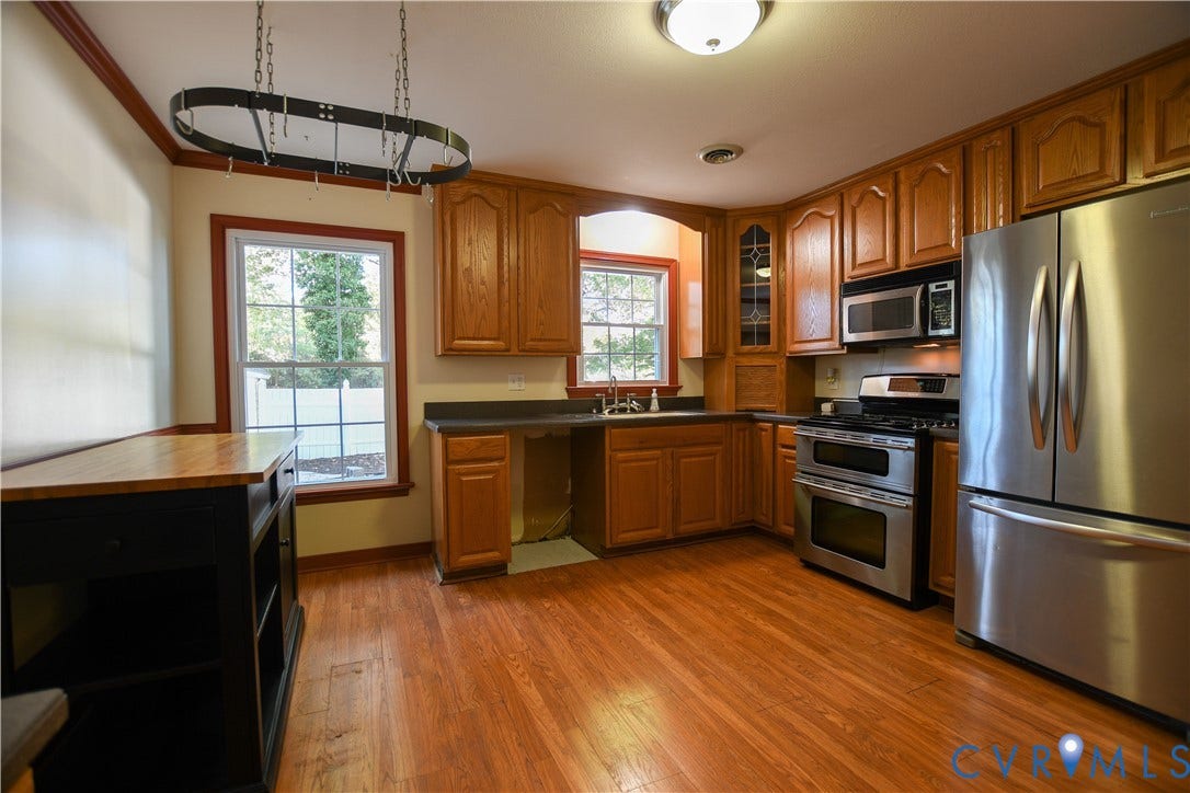 3486 Venter Road, Minors Pines, Aylett, VA 23009 Kitchen featuring wood cabinetry, stainless steel appliances, dark countertops, wood-finish flooring, and multi-pane windows