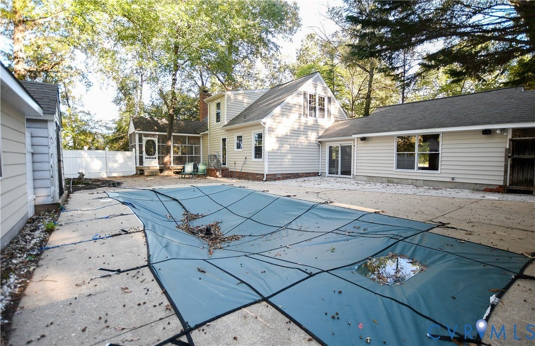 3486 Venter Road, Minors Pines, Aylett, VA 23009 Exterior featuring a swimming pool with a safety cover, expansive concrete patio, screened porch, vinyl siding, and mature tree-lined perimeter