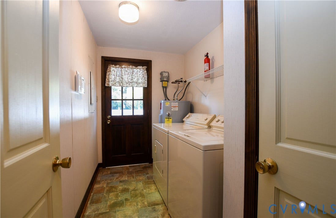 3486 Venter Road, Minors Pines, Aylett, VA 23009 Laundry area featuring multi-tonal tile flooring, a glass-paneled exterior door, and a wall-mounted wire storage shelf