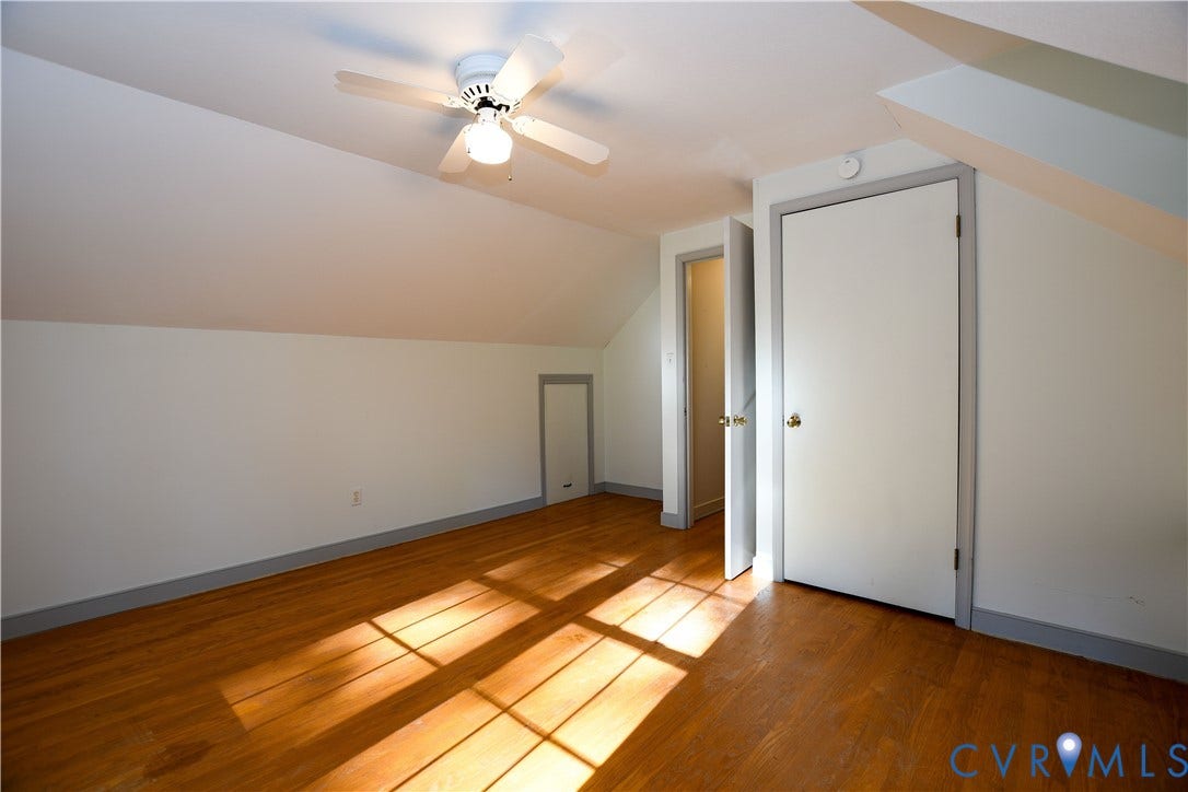 3486 Venter Road, Minors Pines, Aylett, VA 23009 Room featuring wood-finish flooring, vaulted ceilings with a center-mounted ceiling fan, built-in wall storage, and interior door access