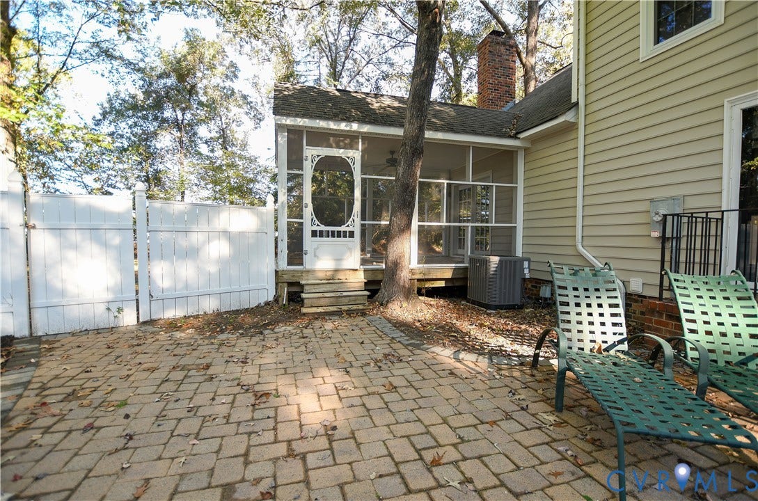 3486 Venter Road, Minors Pines, Aylett, VA 23009 Screened porch featuring a decorative door, paver patio, and white vinyl perimeter fencing