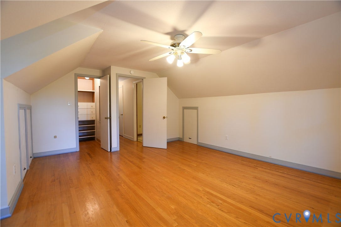 3486 Venter Road, Minors Pines, Aylett, VA 23009 Room featuring wood-finish flooring, vaulted ceilings, a ceiling fan with integrated lighting, built-in wall storage, and interior access doors