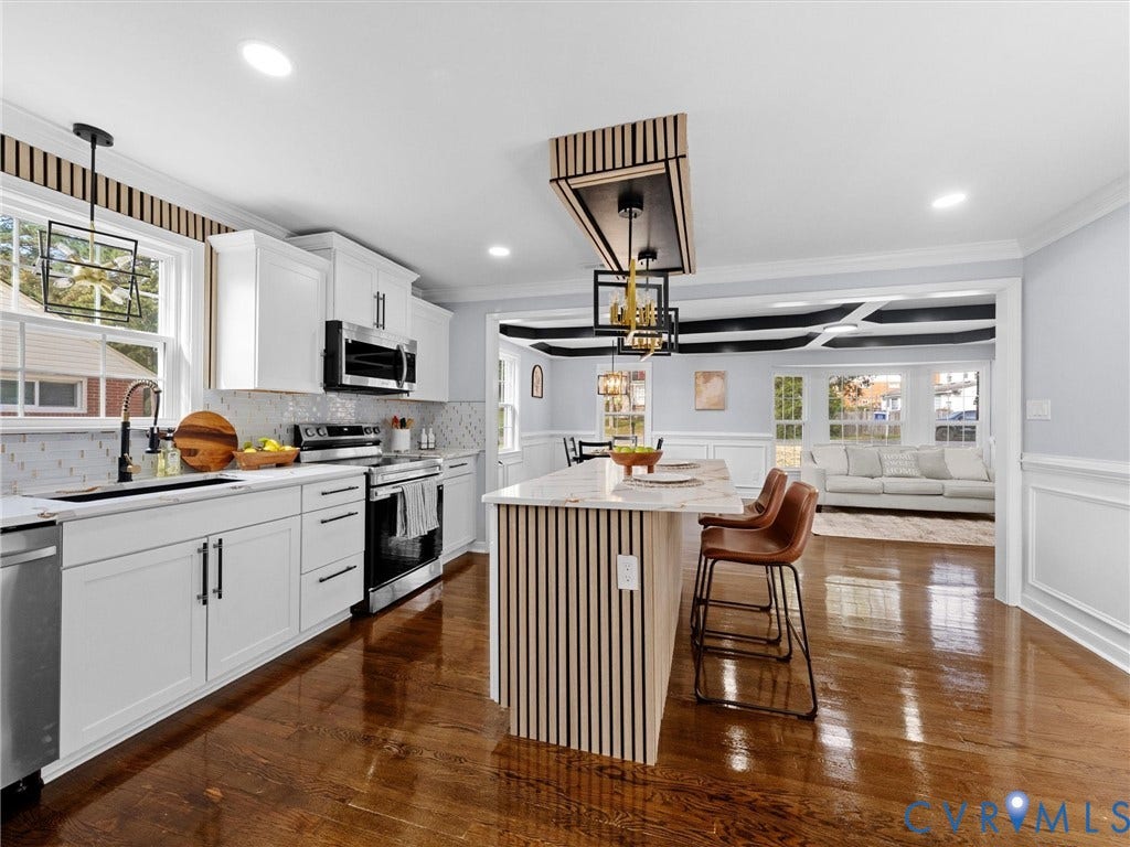 1811 Murdoch Road, Henrico, VA 23229 Kitchen featuring white cabinetry, wood-finish flooring, a kitchen island with vertical wood-slat detailing, stone-finish countertops, and geometric pendant lighting