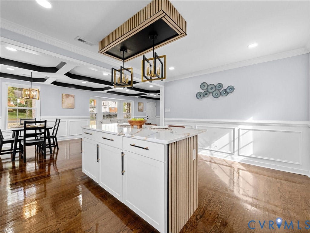 1811 Murdoch Road, Henrico, VA 23229 Kitchen island featuring white cabinetry with vertical wood-slat detailing, stone countertop, coffered ceiling with black accents, and pendant light fixtures