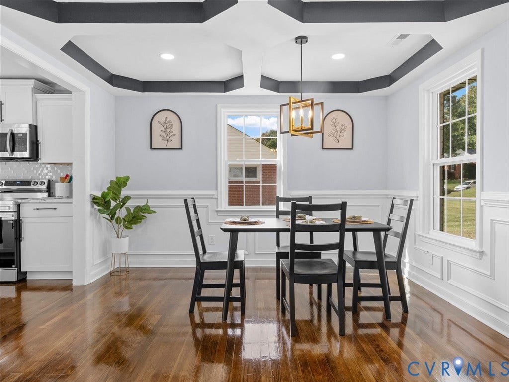 1811 Murdoch Road, Henrico, VA 23229 Dining area featuring a coffered ceiling with dark trim, wainscoting, wood-finish flooring, and a multi-light geometric pendant fixture