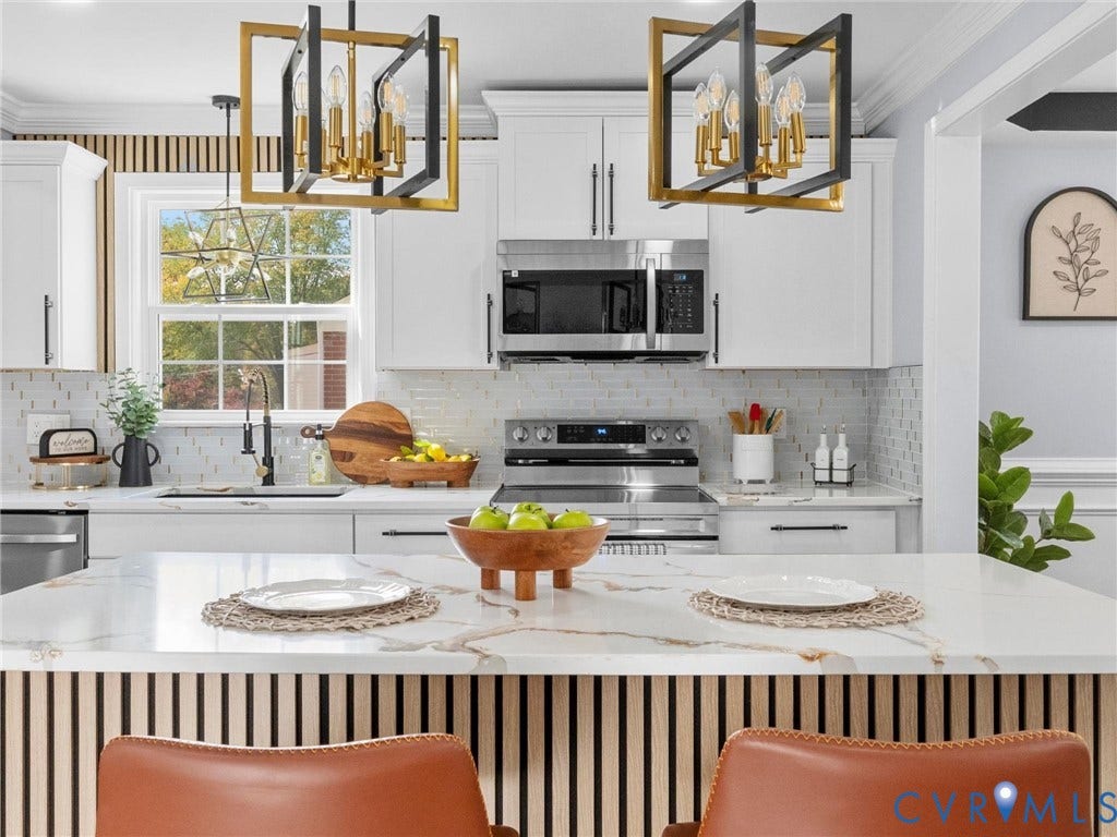 1811 Murdoch Road, Henrico, VA 23229 Kitchen featuring white shaker-style cabinetry, a central island with a wood-slat base and quartz countertop, stainless steel appliances, and dual geometric-frame pendant light fixtures