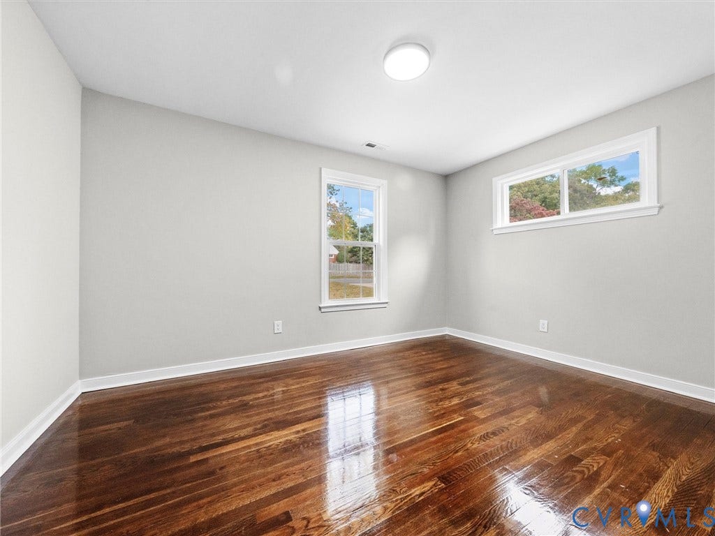 1811 Murdoch Road, Henrico, VA 23229 Neutral wall tones, polished wood-finish flooring, and multiple windows providing natural light