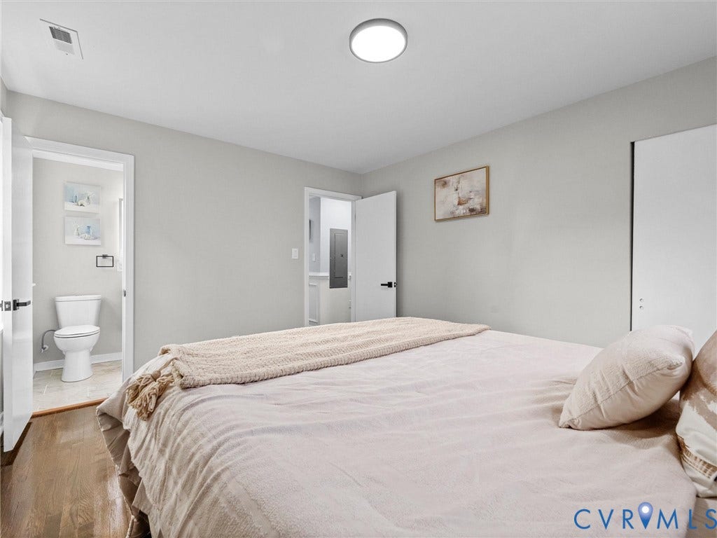 1811 Murdoch Road, Henrico, VA 23229 Neutral-toned interior featuring wood-finish flooring, a flush-mount ceiling light fixture, and a sliding-door closet