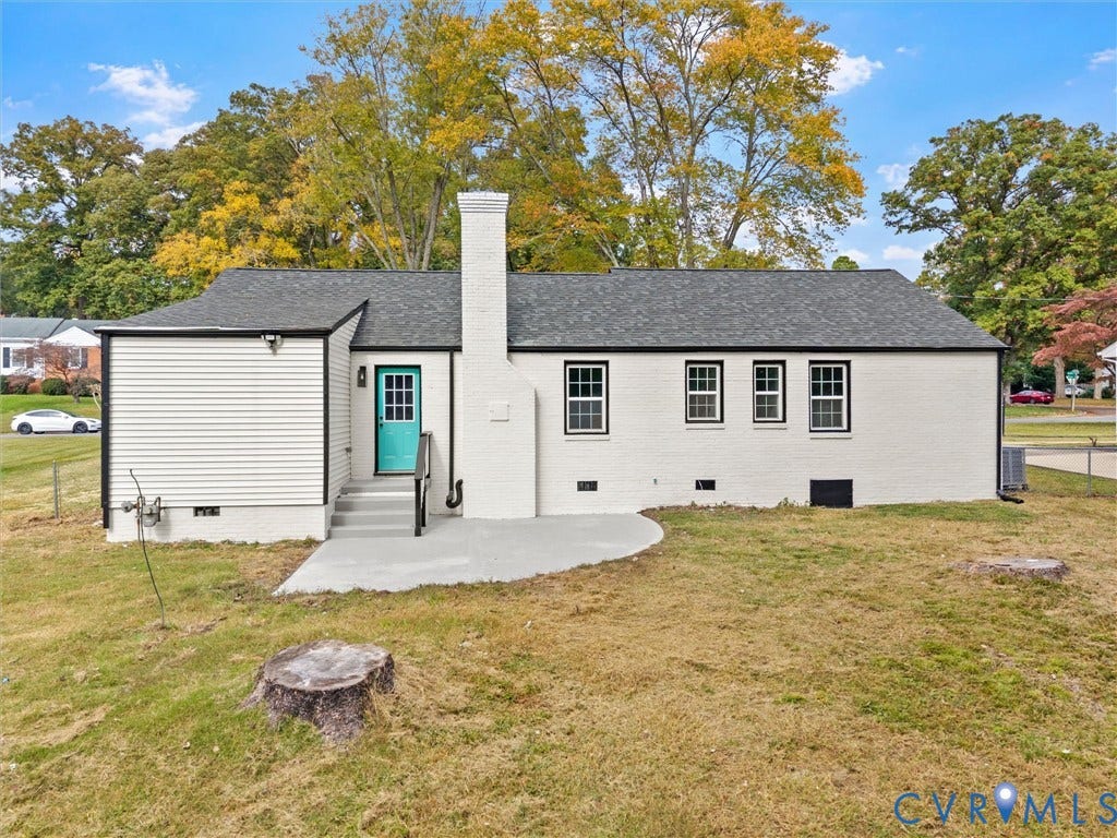 1811 Murdoch Road, Henrico, VA 23229 Painted brick and siding exterior featuring a centered masonry chimney, rear concrete patio, and grid-pattern window panes