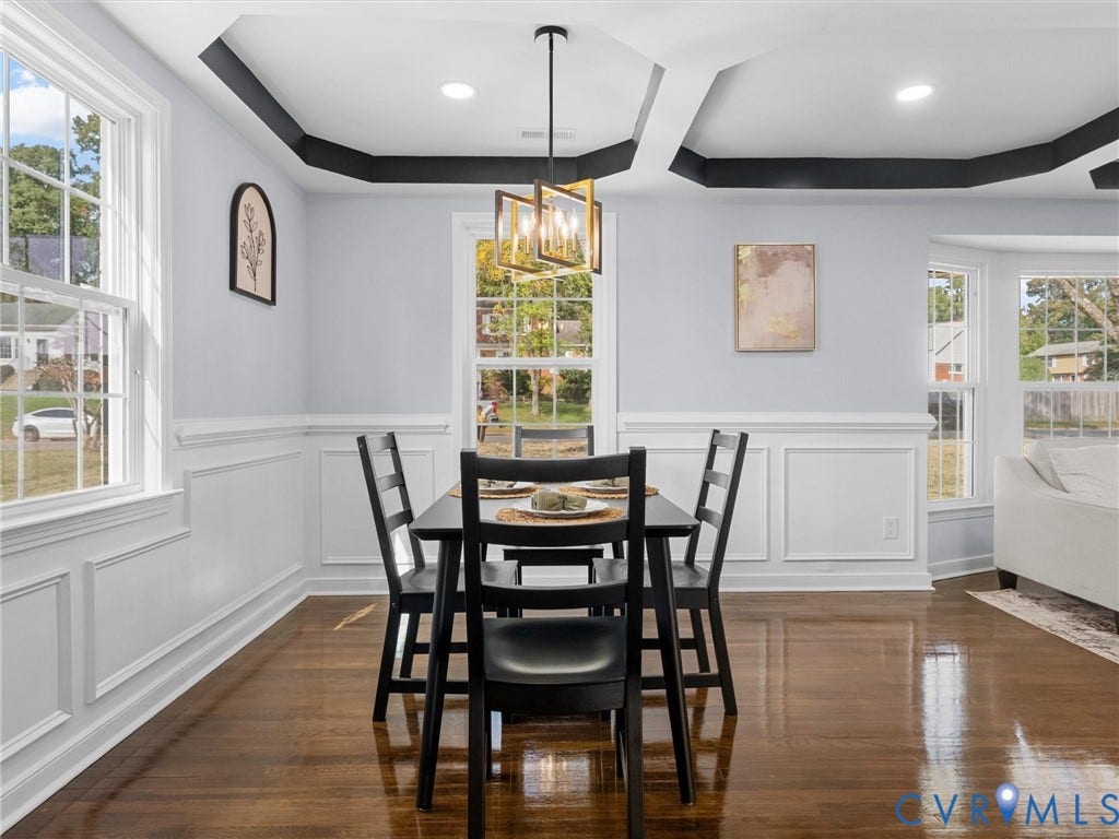1811 Murdoch Road, Henrico, VA 23229 Dining area featuring a tray ceiling with high-contrast crown molding, polished wood-finish flooring, wainscoting, and a geometric metal chandelier