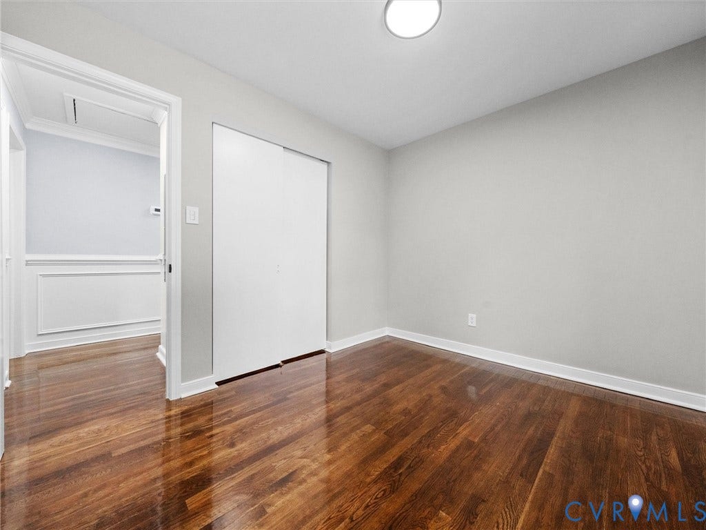 1811 Murdoch Road, Henrico, VA 23229 Interior room featuring polished wood-finish flooring, neutral wall paint, a double-panel closet door, and a flush-mount ceiling light fixture