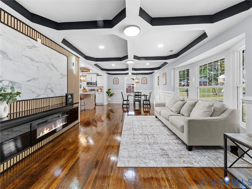 1811 Murdoch Road, Henrico, VA 23229 Coffered ceiling with contrasting trim, stone-finish accent wall, built-in horizontal fireplace, wood-finish flooring, and crown molding