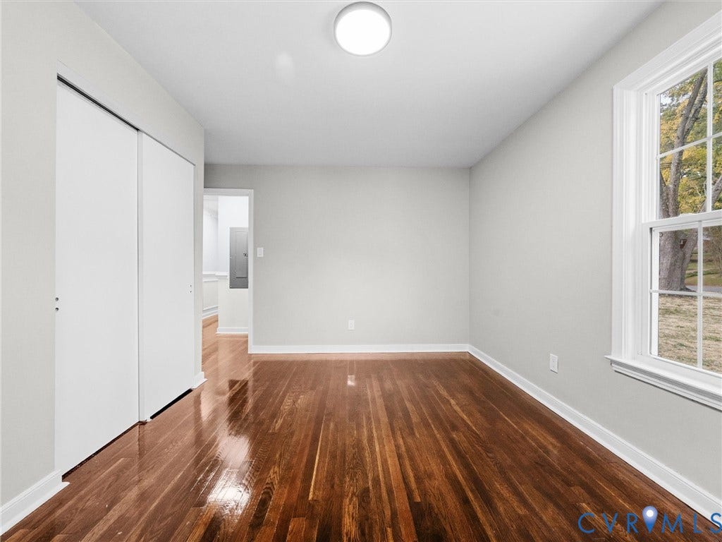 1811 Murdoch Road, Henrico, VA 23229 Polished wood-finish flooring, dual-panel sliding closet doors, neutral wall palette, and double-hung window with exterior landscape exposure
