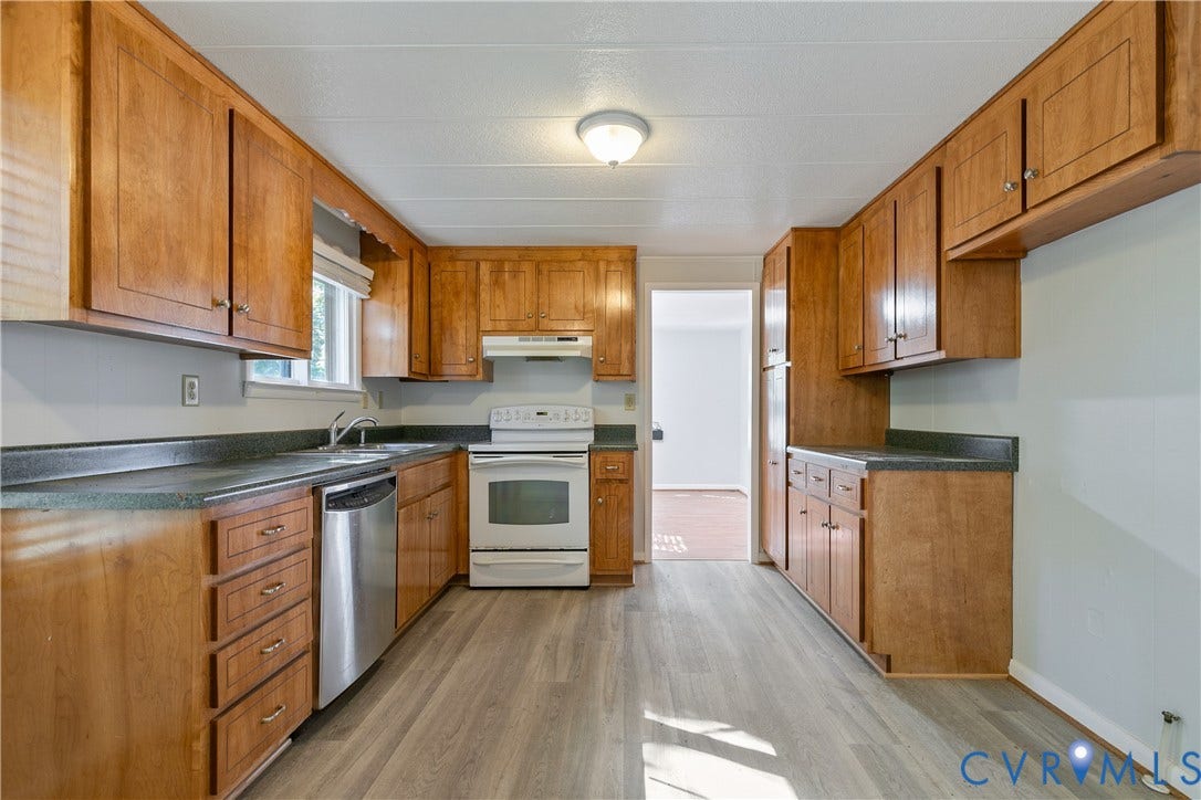20311 McKenney Highway, Dinwiddie, VA 23882 Kitchen featuring wood cabinetry, solid surface countertops, wood-finish flooring, a stainless steel dishwasher, and a white range