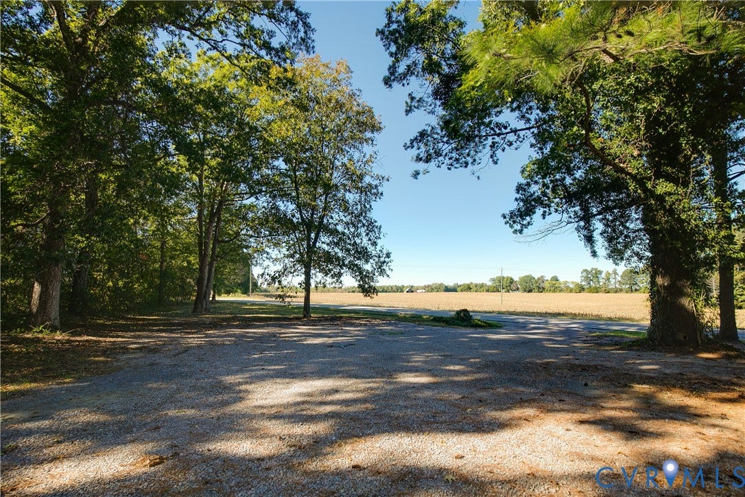 20311 McKenney Highway, Dinwiddie, VA 23882 Expansive acreage featuring a gravel surface, mature timber, and open fields