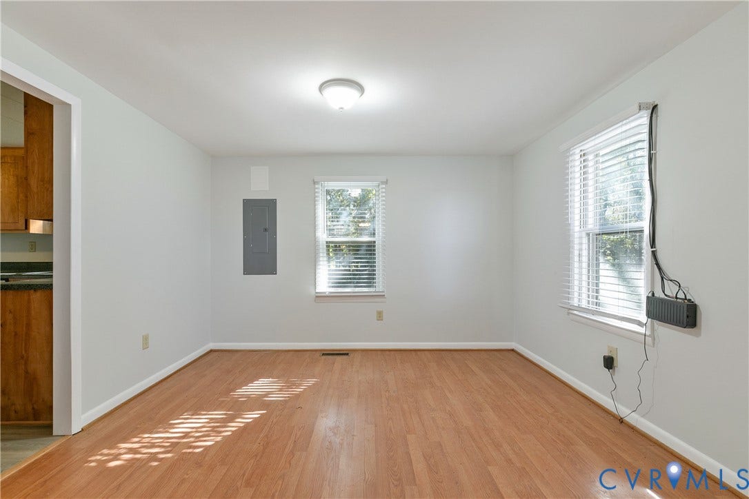 20311 McKenney Highway, Dinwiddie, VA 23882 Interior space featuring wood-finish flooring, two windows with horizontal blinds, and a central ceiling-mounted light fixture
