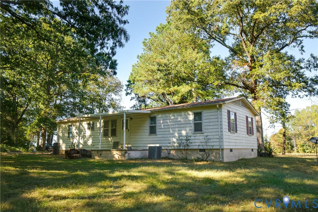 20311 McKenney Highway, Dinwiddie, VA 23882 Exterior siding, covered porch, and mature trees situated on a spacious lot