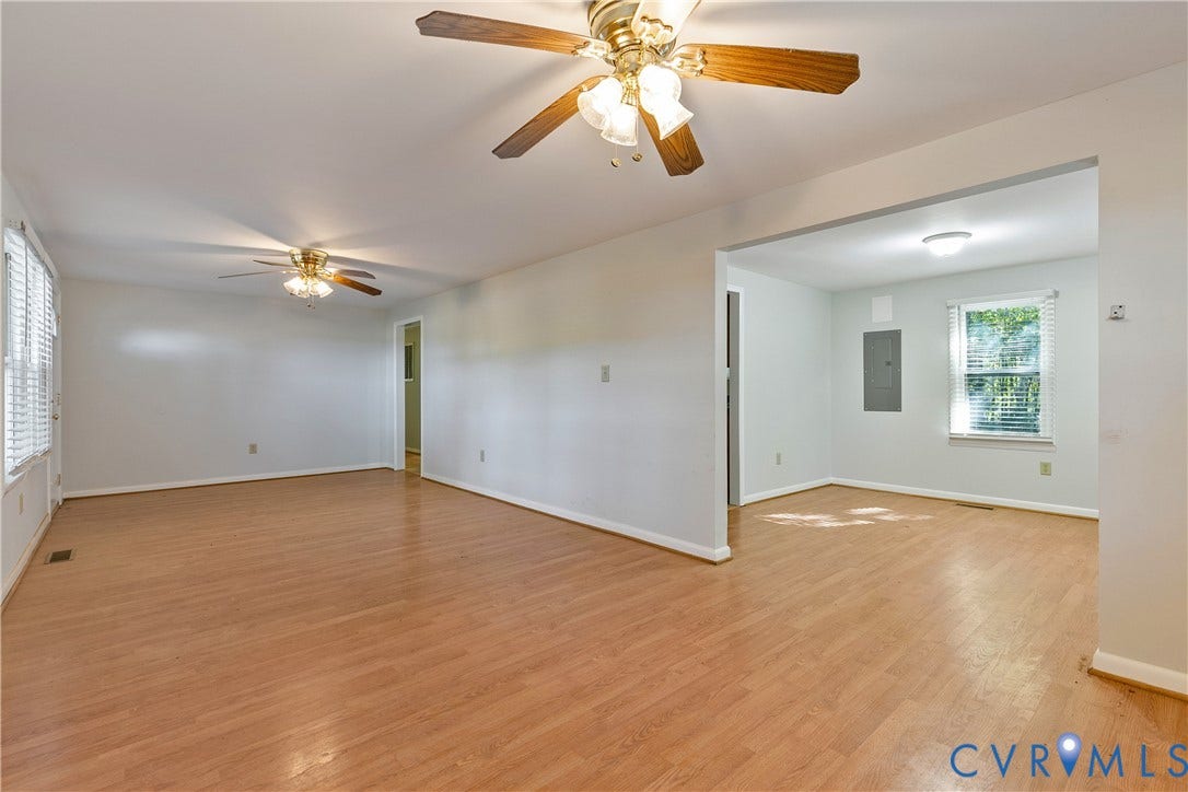 20311 McKenney Highway, Dinwiddie, VA 23882 Open interior featuring wood-finish flooring, two ceiling fans with integrated light fixtures, and multi-pane windows