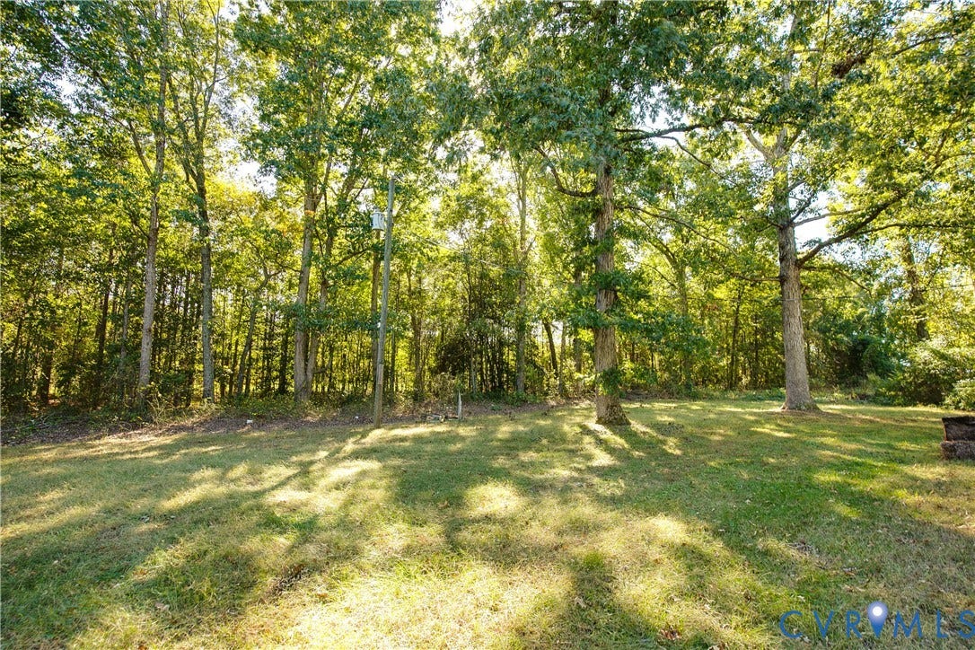 20311 McKenney Highway, Dinwiddie, VA 23882 Expansive backyard featuring a grass lawn and mature trees