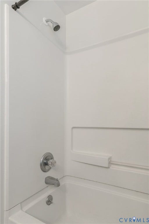 20311 McKenney Highway, Dinwiddie, VA 23882 Bathtub and shower surround with a integrated soap ledge, chrome finish plumbing fixtures, and a clear acrylic handle