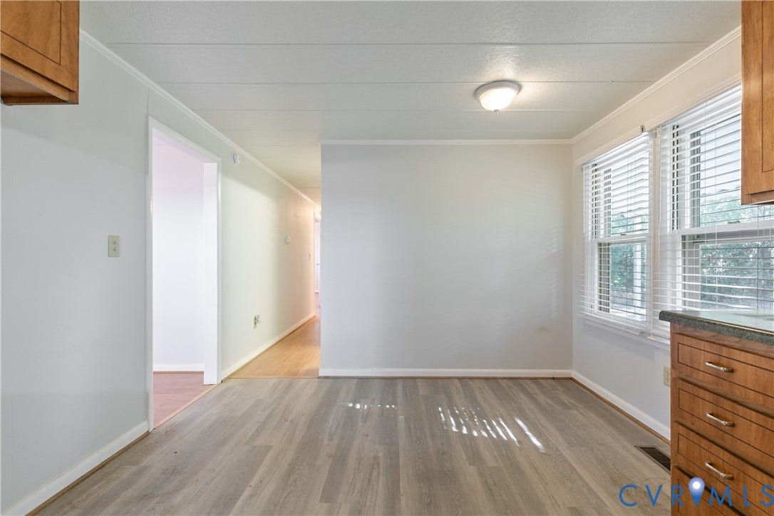 20311 McKenney Highway, Dinwiddie, VA 23882 Wood-finish flooring, light-toned walls, flush-mount ceiling lighting, and double-window configuration with horizontal blinds