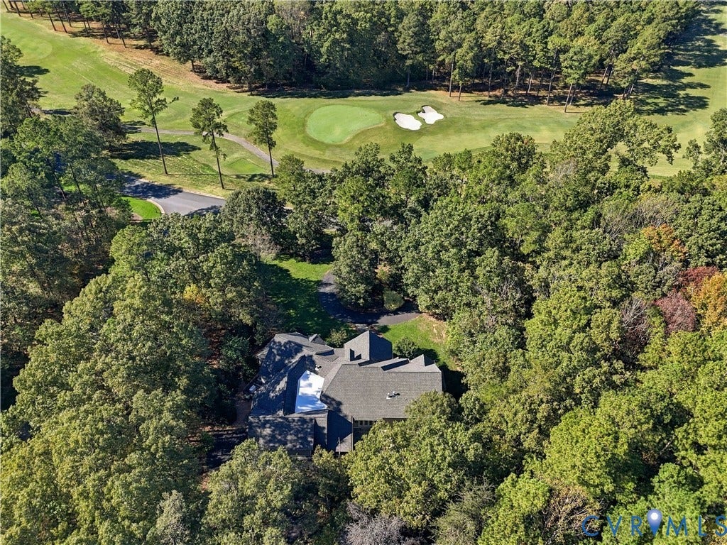 3056 Greywalls Drive, Powhatan, VA 23139 Aerial perspective featuring a multi-gabled roofline, private paved driveway, and established woodland setting bordering a golf course