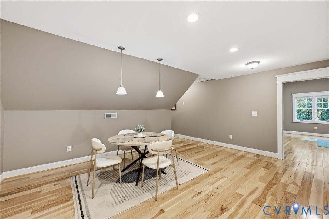 3056 Greywalls Drive, Powhatan, VA 23139 Vaulted ceiling featuring dual pendant light fixtures, wood-finish flooring, and crown molding