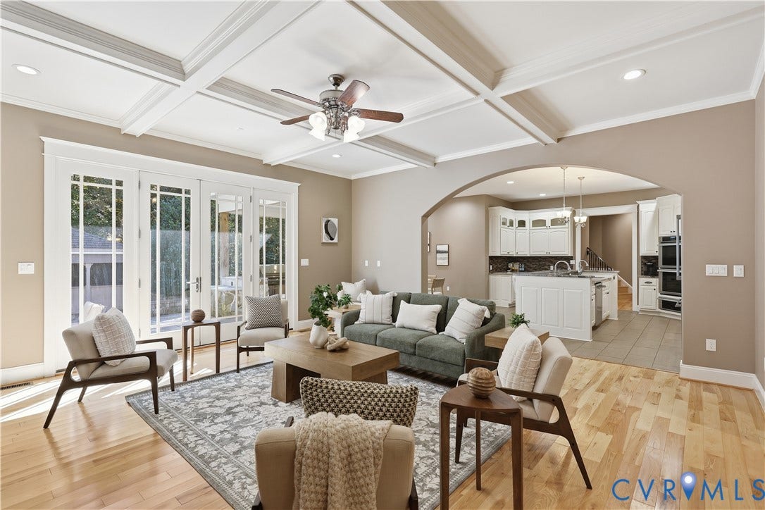 3056 Greywalls Drive, Powhatan, VA 23139 Coffered ceilings with recessed lighting, wood-finish flooring, multi-pane French doors, and an arched entryway leading to a kitchen with white cabinetry and a central island