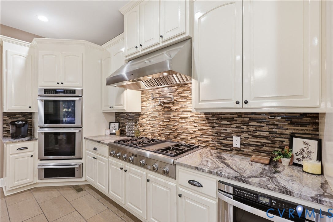 3056 Greywalls Drive, Powhatan, VA 23139 Kitchen featuring white cabinetry, stone-surface countertops, horizontal tile backsplash, stainless steel double wall ovens, and a professional-style gas range with a stainless steel vent hood