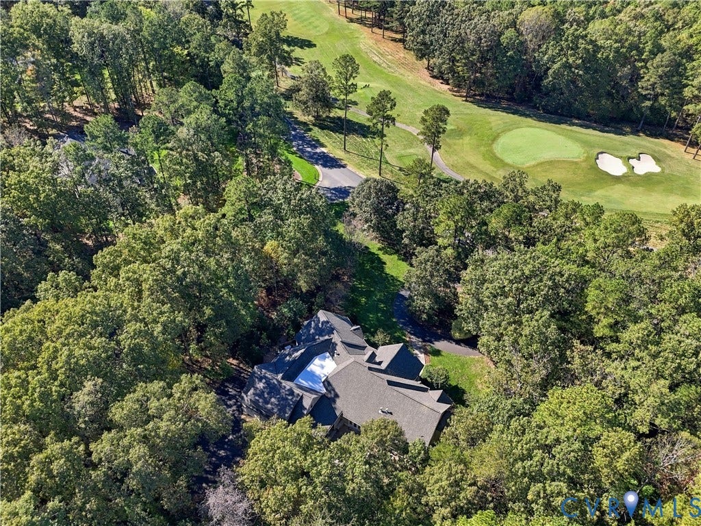 3056 Greywalls Drive, Powhatan, VA 23139 Aerial perspective featuring a multi-gabled roofline, secluded wooded lot, and paved driveway