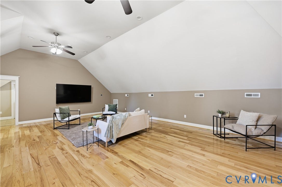3056 Greywalls Drive, Powhatan, VA 23139 Vaulted ceiling featuring neutral wall tones, wood-finish flooring, and dual ceiling fans