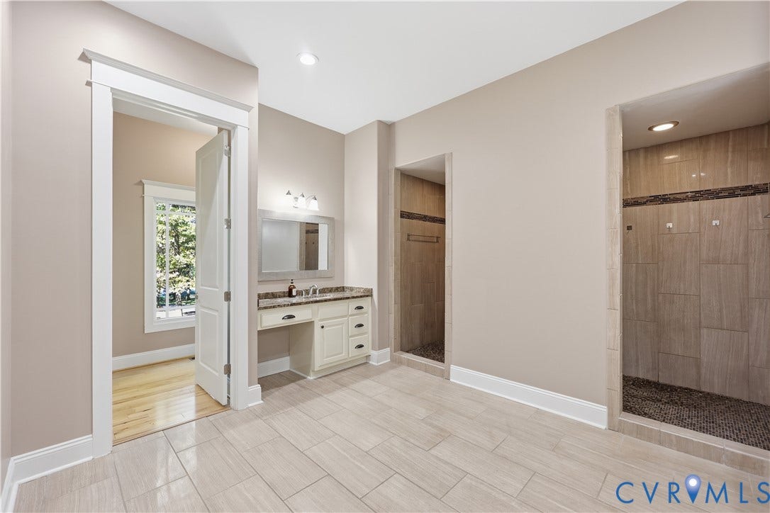 3056 Greywalls Drive, Powhatan, VA 23139 Primary Bathroom 2. Built-in vanity featuring stone-surfaced countertop, walk-in shower with stone tile surround, pebble-style shower floor, and tile flooring
