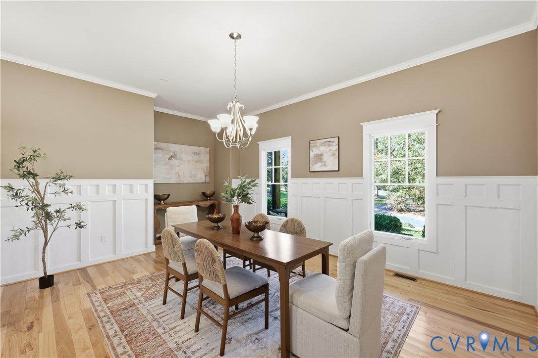 3056 Greywalls Drive, Powhatan, VA 23139 Dining area featuring wood-finish flooring, white wainscoting, crown molding, and a multi-arm chandelier
