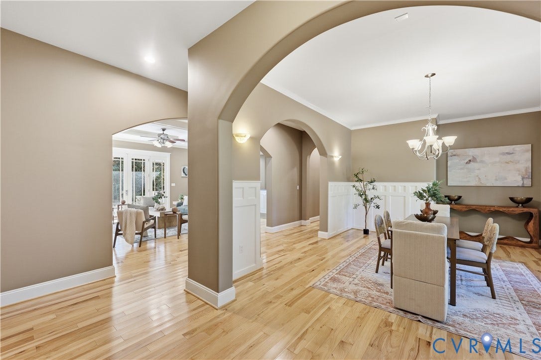 3056 Greywalls Drive, Powhatan, VA 23139 Interior featuring arched architectural pass-throughs, wood-finish flooring, wainscoting, recessed lighting, and a multi-arm chandelier