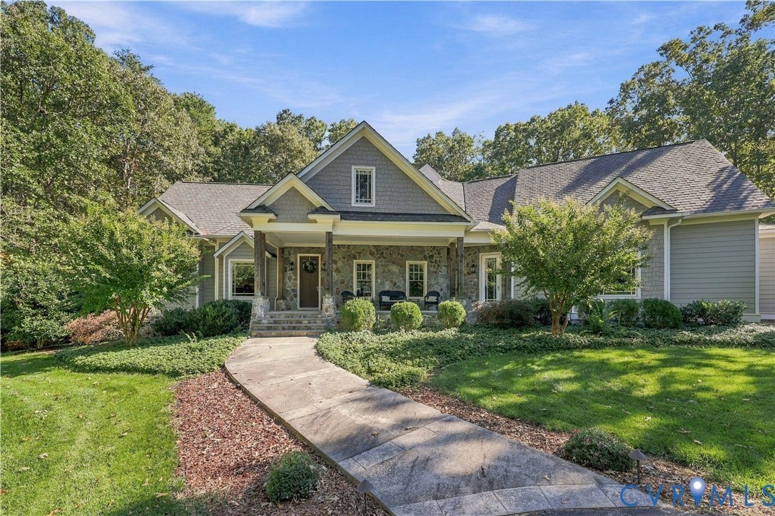 3056 Greywalls Drive, Powhatan, VA 23139 Craftsman-style exterior featuring stone veneer siding, decorative shingle detailing, a covered front porch, and a stamped concrete walkway