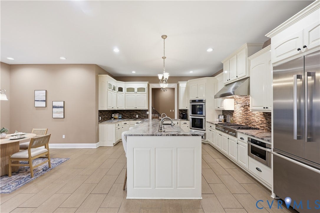 3056 Greywalls Drive, Powhatan, VA 23139 Kitchen featuring white cabinetry, stone-surface island, stainless steel built-in double wall oven, cooktop with a stainless steel range hood, and tile flooring