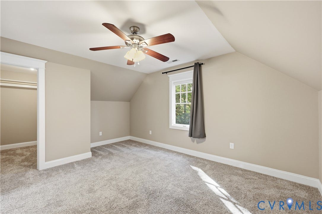 3056 Greywalls Drive, Powhatan, VA 23139 Upstairs Bedroom Room featuring sloped ceilings, wall-to-wall carpeting, a multi-blade ceiling fan with integrated lighting, and a single-hung window with decorative muntins