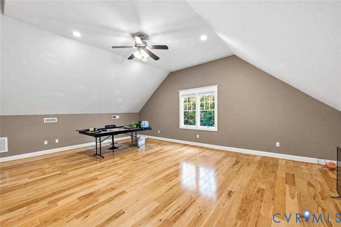 3056 Greywalls Drive, Powhatan, VA 23139 Vaulted ceiling featuring a central multi-blade ceiling fan, recessed lighting, double-hung windows, and wood-finish flooring