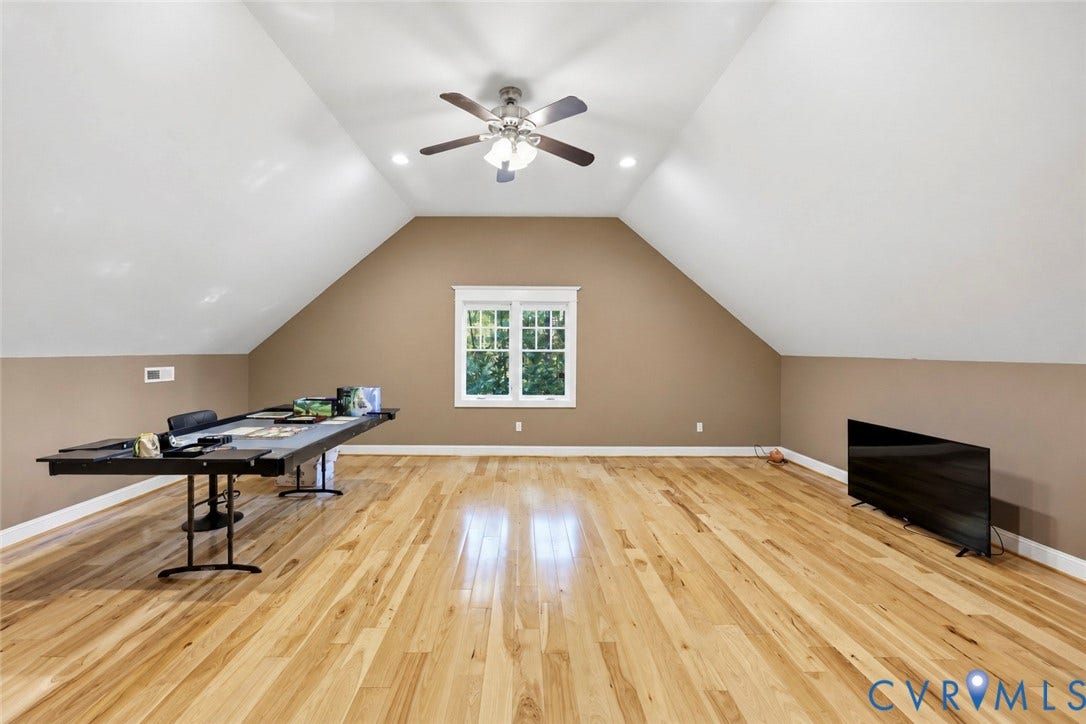 3056 Greywalls Drive, Powhatan, VA 23139 Vaulted ceiling room featuring wood-finish flooring, recessed lighting, a center ceiling fan with integrated light fixture, and a multi-pane window