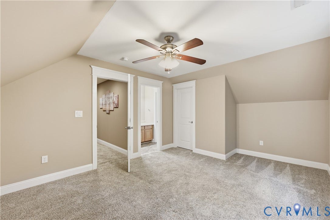 3056 Greywalls Drive, Powhatan, VA 23139 Upstairs Bedroom, Neutral interior space featuring carpeted flooring, vaulted ceilings, and a ceiling fan with integrated light fixture
