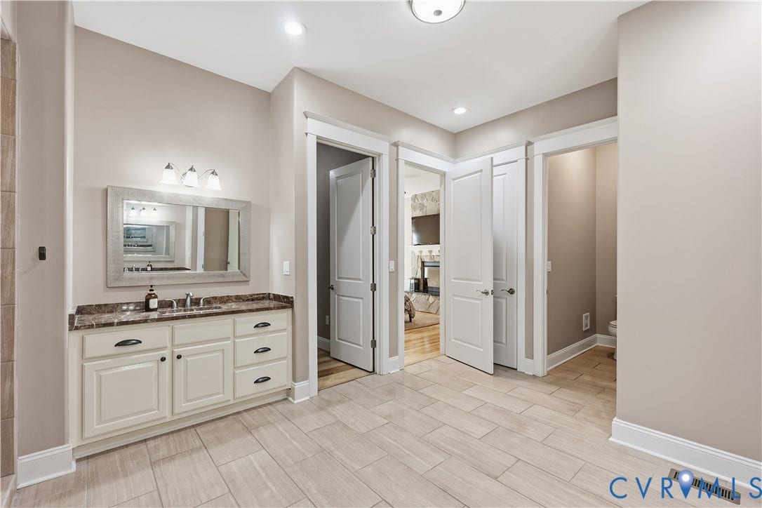 3056 Greywalls Drive, Powhatan, VA 23139 Primary Bathroom 2 featuring a vanity with neutral cabinetry, a stone-finish countertop, a rectangular framed mirror, inset panel doors, and tile flooring