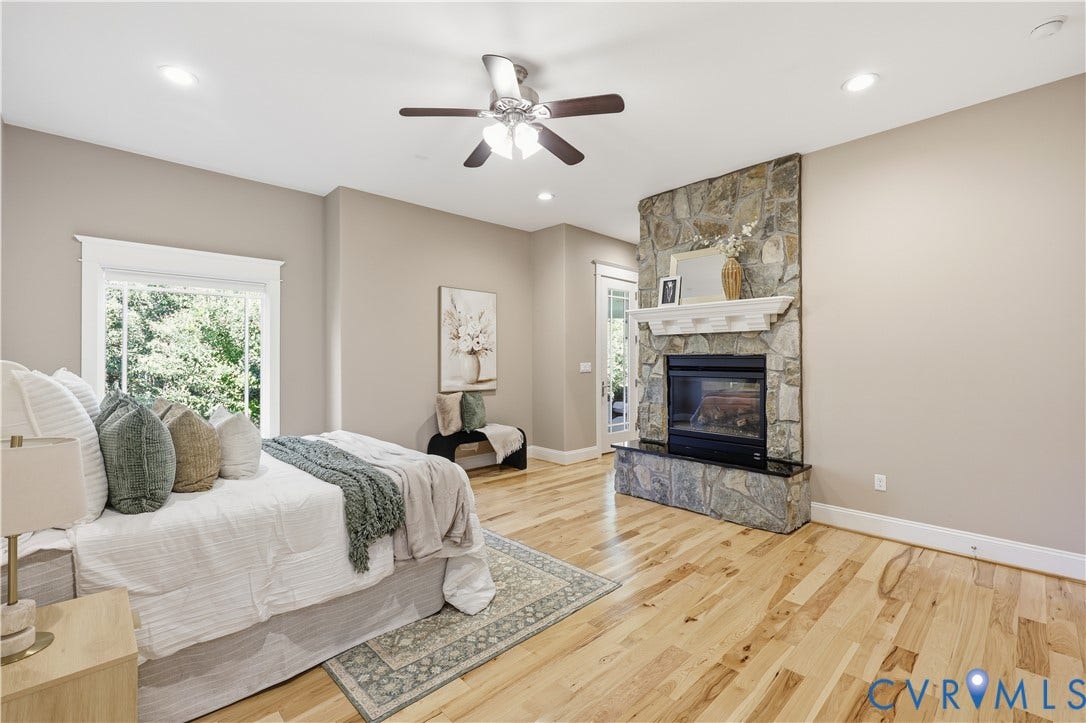 3056 Greywalls Drive, Powhatan, VA 23139 Stone fireplace with a mantle, wood-finish flooring, recessed lighting, ceiling fan, and large-format window