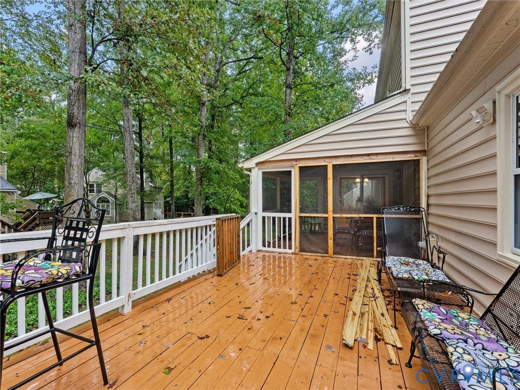 Elevated wood-plank deck featuring a white railing, integrated wood-framed screened-in porch, and siding exterior