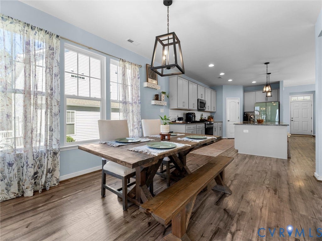5726 Gossamer Place, Wynwood At FoxCreek, Moseley, VA 23120 Open-concept dining and kitchen area featuring wood-finish flooring, recessed lighting, industrial-style pendant lighting, and light gray cabinetry