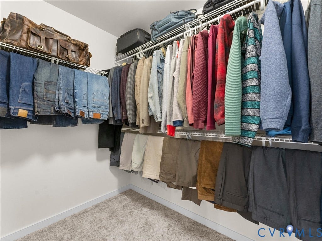 5726 Gossamer Place, Wynwood At FoxCreek, Moseley, VA 23120 Walk-in closet featuring tiered wire shelving and neutral-toned carpeting
