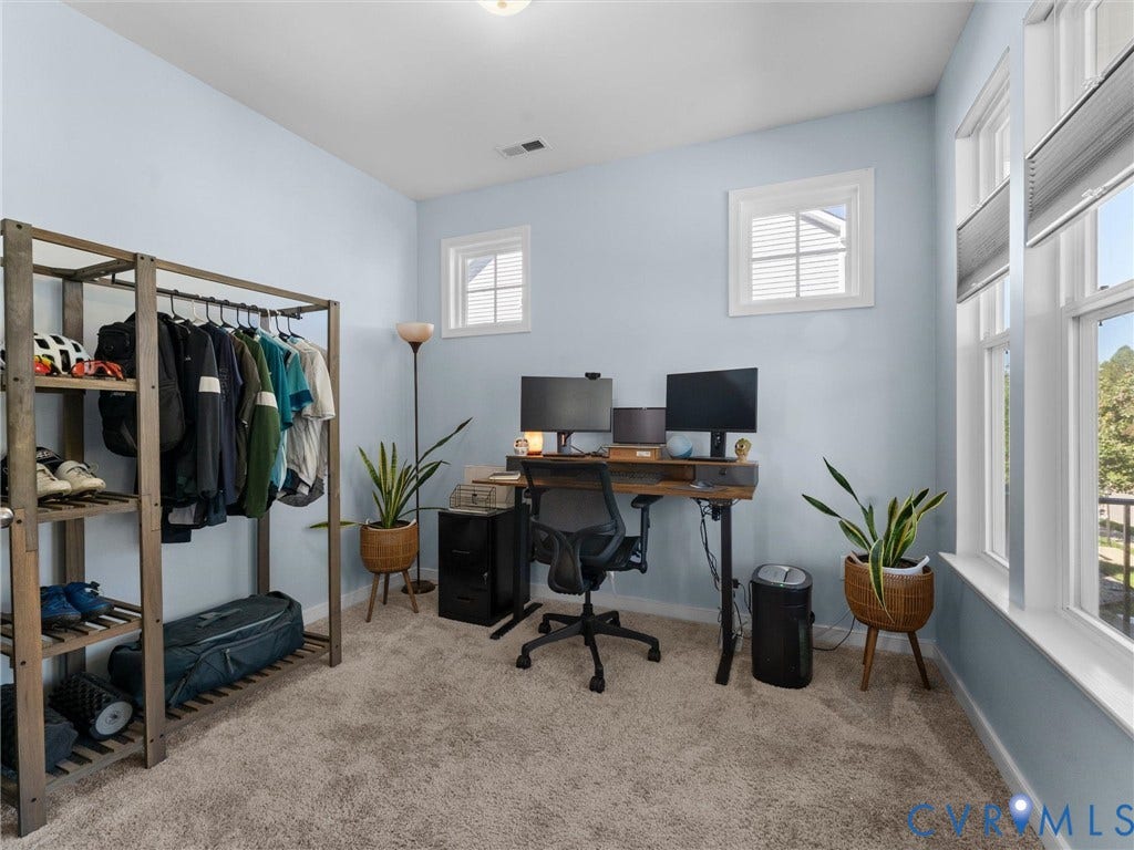 5726 Gossamer Place, Wynwood At FoxCreek, Moseley, VA 23120 Room featuring neutral-toned carpeting, dual-pane windows with white trim, and light blue wall finish