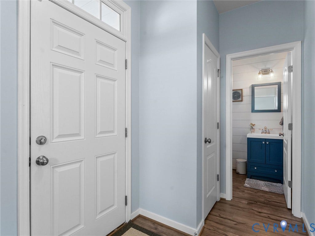 5726 Gossamer Place, Wynwood At FoxCreek, Moseley, VA 23120 Entryway featuring a white paneled door with transom window and wood-finish flooring